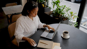 Marketer segmenting fashion email list on laptop