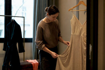Woman adjusting satin midi dress cuff