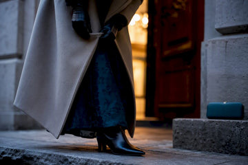 Winter wedding guest layering coat over dress