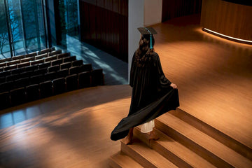 Graduate preparing outfit for stage photos