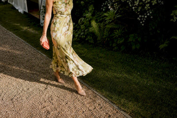 Guest wearing midi outfit at garden wedding